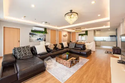 Luxurious open-plan living room with elegant decor and modern kitchen