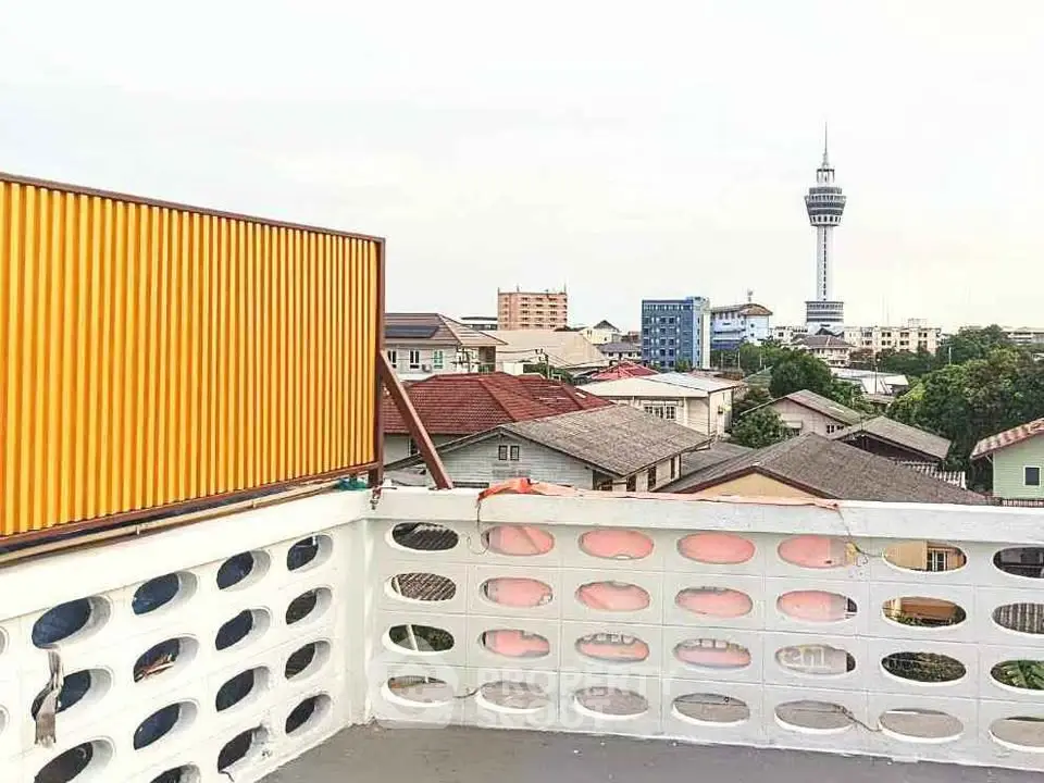 Stunning rooftop view with cityscape and iconic tower in the background