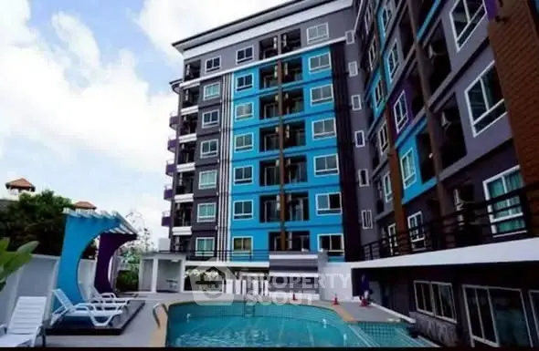 Modern apartment building with pool and vibrant exterior design