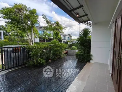 Charming residential entrance with lush greenery and modern design, perfect for serene living.
