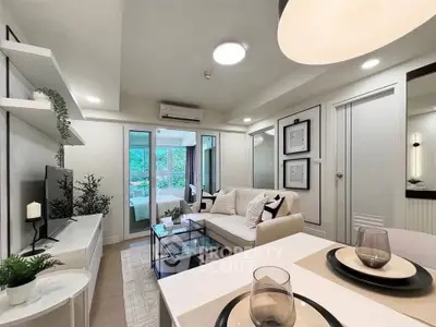 Modern living room with stylish decor and open layout, featuring a cozy seating area and dining space.