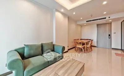 Spacious living room with modern furniture and dining area in a stylish apartment.