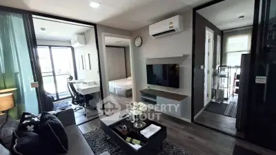 Modern apartment interior with living room, bedroom, and study area, featuring sleek design and natural light.