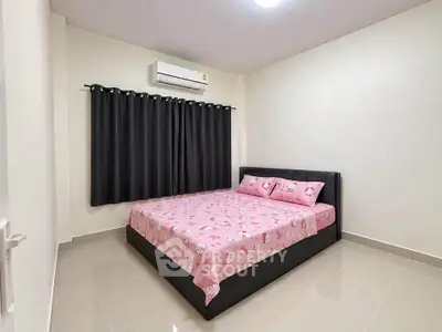 Spacious bedroom with modern air conditioning and stylish decor, perfect for comfort and relaxation.