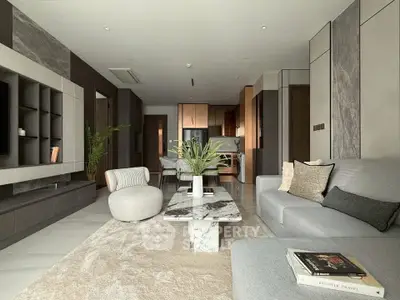 Luxurious modern living room with stylish decor and open kitchen layout.