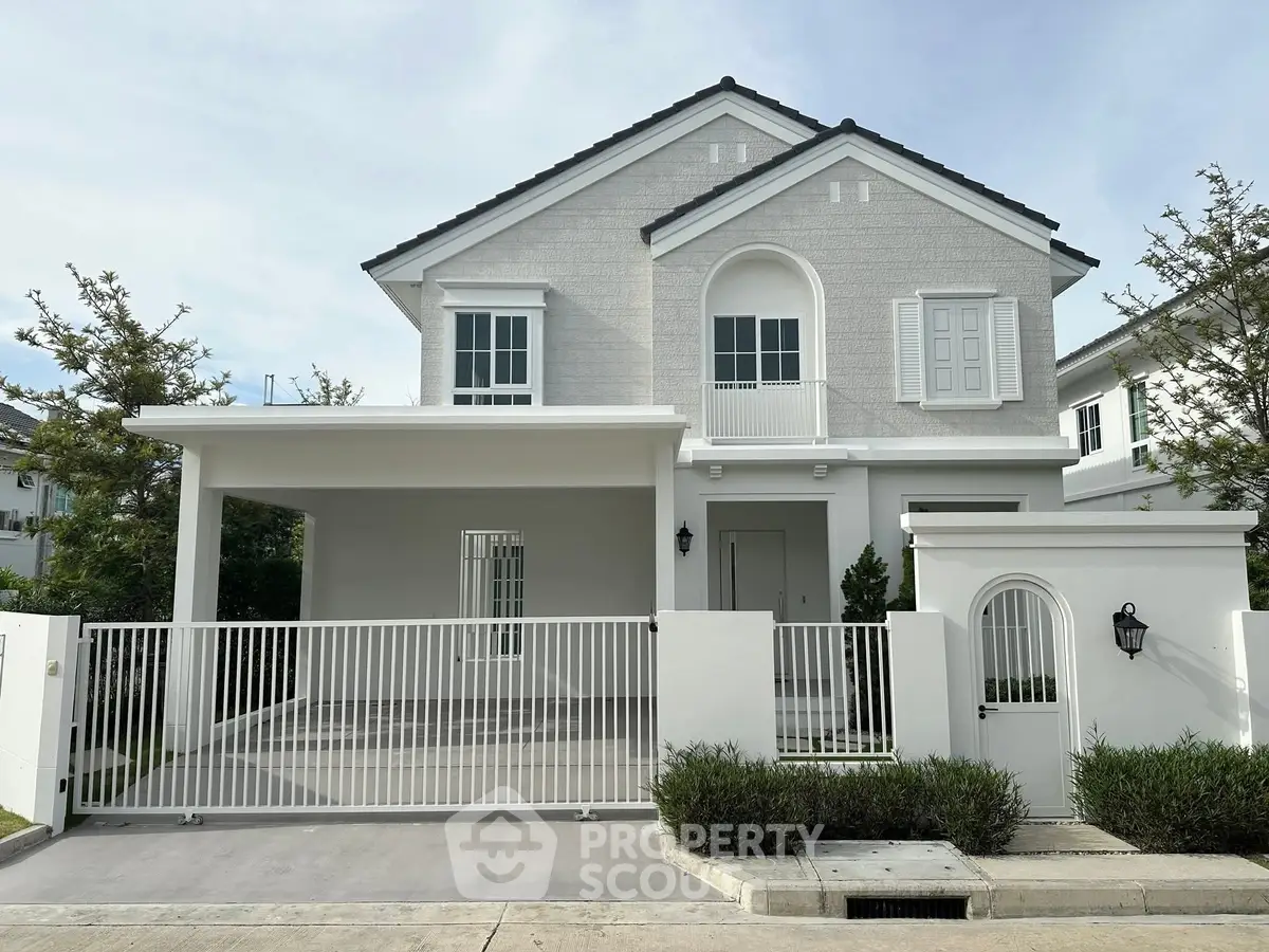 Charming two-story house with modern design and gated entrance in a serene neighborhood.