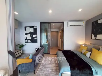 Modern bedroom with stylish decor and cozy seating area in a contemporary apartment.