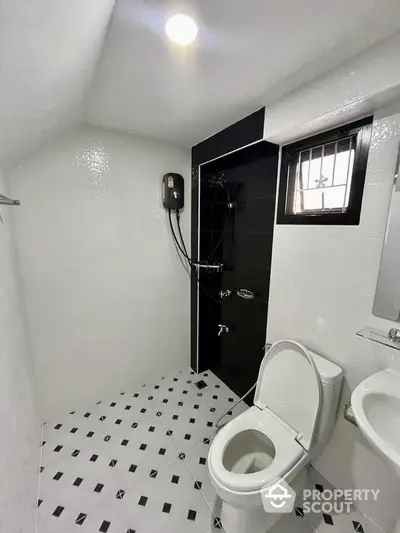 Modern bathroom with sleek black and white tiles and contemporary fixtures