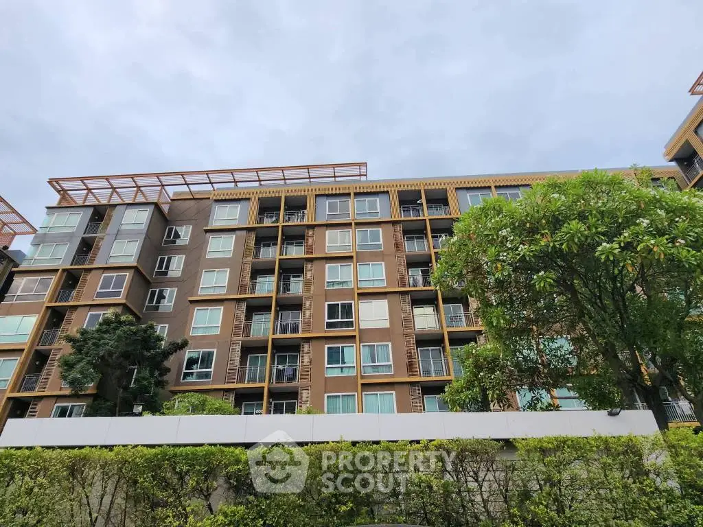 Modern apartment building with lush greenery and contemporary design.