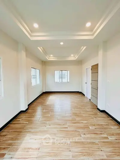 Spacious modern living room with elegant ceiling design and wooden flooring