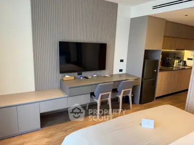Modern studio apartment with sleek kitchen and stylish living area, perfect for urban living.