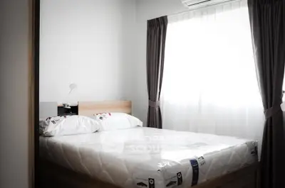 Bright and cozy bedroom with natural light and modern furnishings.