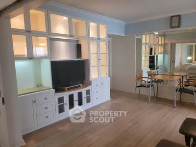 Spacious living room with built-in cabinets and modern dining area