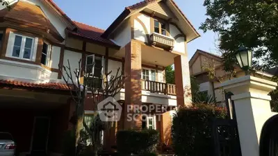 Charming two-story house with classic architecture and lush greenery