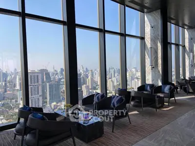 Stunning high-rise view from luxurious modern lounge with panoramic cityscape.
