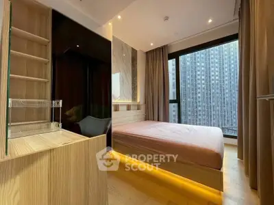 Modern bedroom with large window and city view, featuring sleek wooden furniture and ambient lighting.