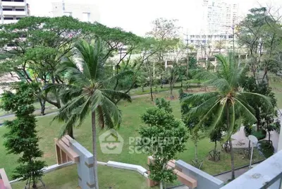 Lush green garden view with palm trees in urban setting