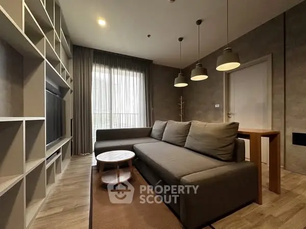 Modern living room with stylish sofa and shelving unit, perfect for relaxation and entertainment.