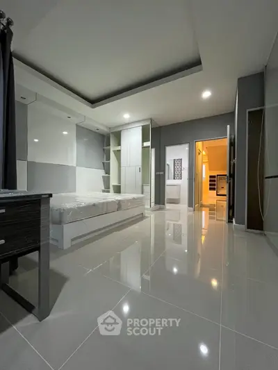 Modern bedroom with sleek design and glossy tiled flooring