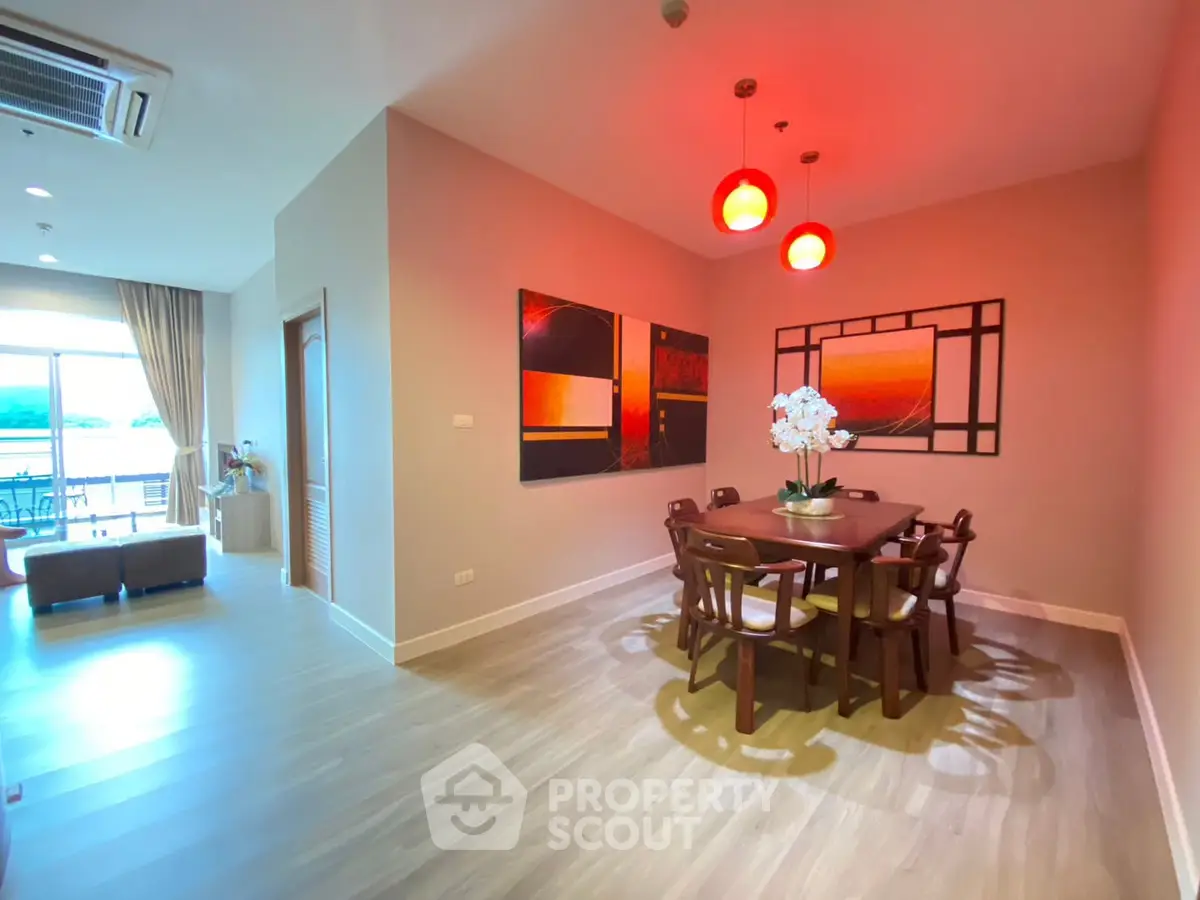 Spacious dining area with modern decor and natural light in a stylish apartment.