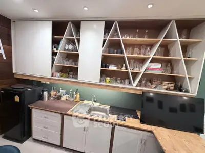 Modern kitchen with unique shelving and sleek appliances