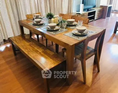 Elegant dining area with wooden table and chairs in a modern living space.