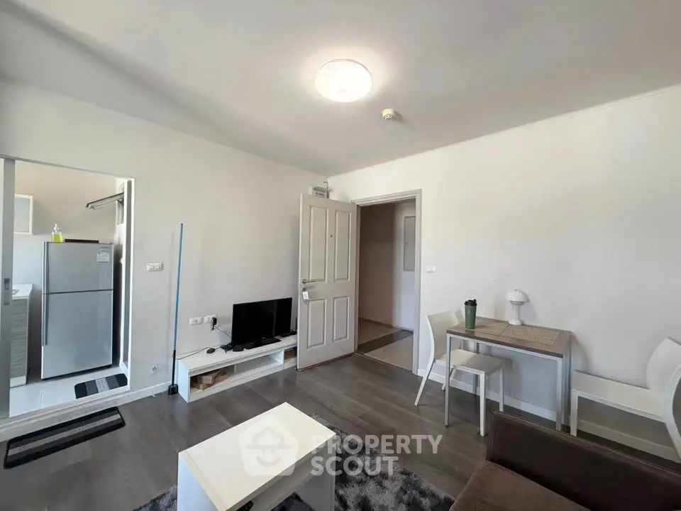 Modern living room with sleek furniture and open kitchen layout