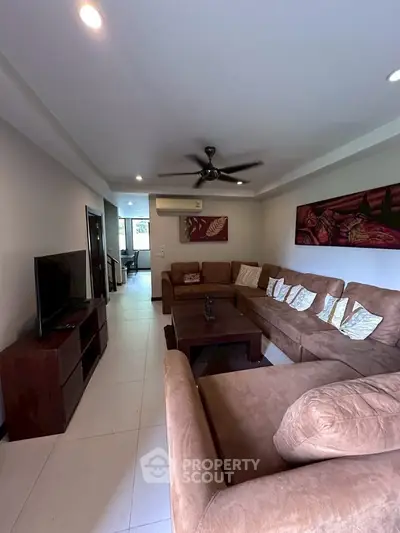 Spacious living room with modern decor and comfortable seating in a stylish apartment.