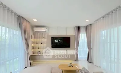 Spacious modern living room with large windows and elegant decor