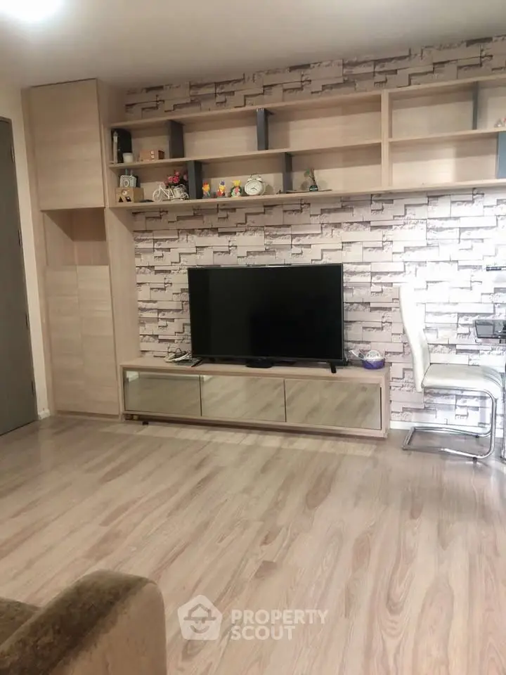 Modern living room with stylish brick accent wall and sleek wooden flooring