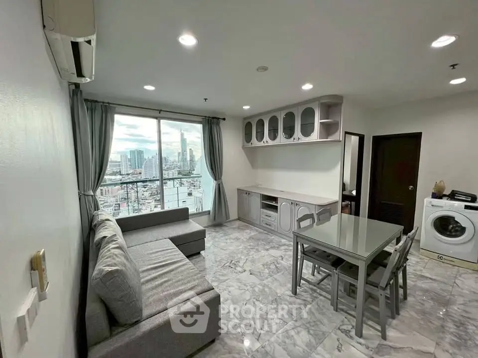 Modern living room with city view, featuring sleek furniture and marble flooring.