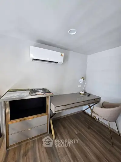 Modern study room with sleek desk and chair, featuring air conditioning and stylish decor.