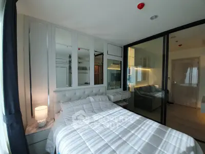 Modern bedroom with glass partition and cozy lighting