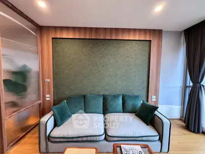 Modern living room with stylish green sofa and wooden accents