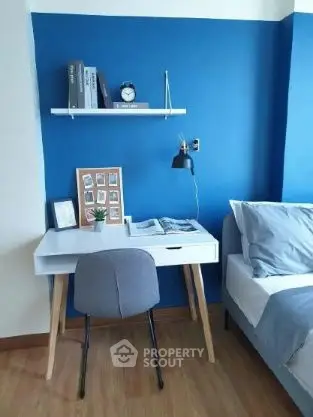 Modern study nook with blue accent wall and stylish decor