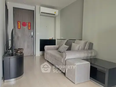 Modern living room with sleek gray sofa and air conditioning, perfect for urban living.