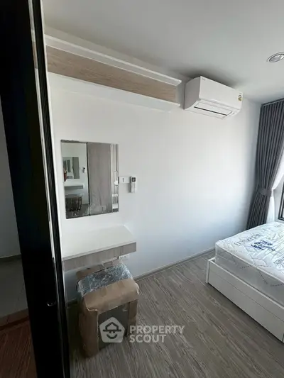 Modern bedroom with air conditioning and stylish decor in a contemporary apartment.