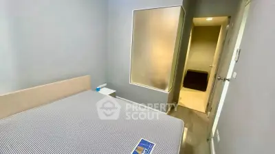 Cozy bedroom with modern design and neutral tones, featuring a comfortable bed and ambient lighting.