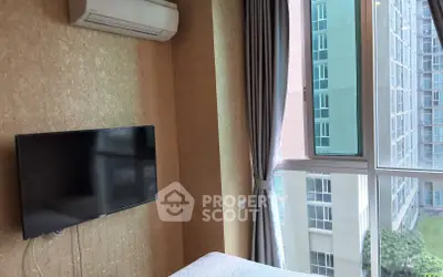 Modern bedroom with air conditioning and large window offering city view