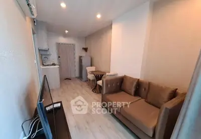 Modern living room with cozy sofa and open kitchen layout