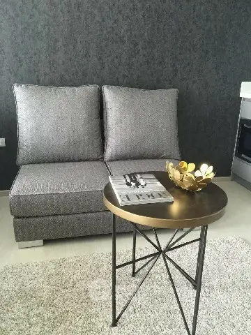 Stylish modern living room with gray sofa and elegant round table