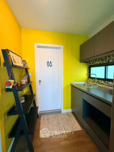 Modern kitchen with vibrant yellow walls and sleek cabinetry
