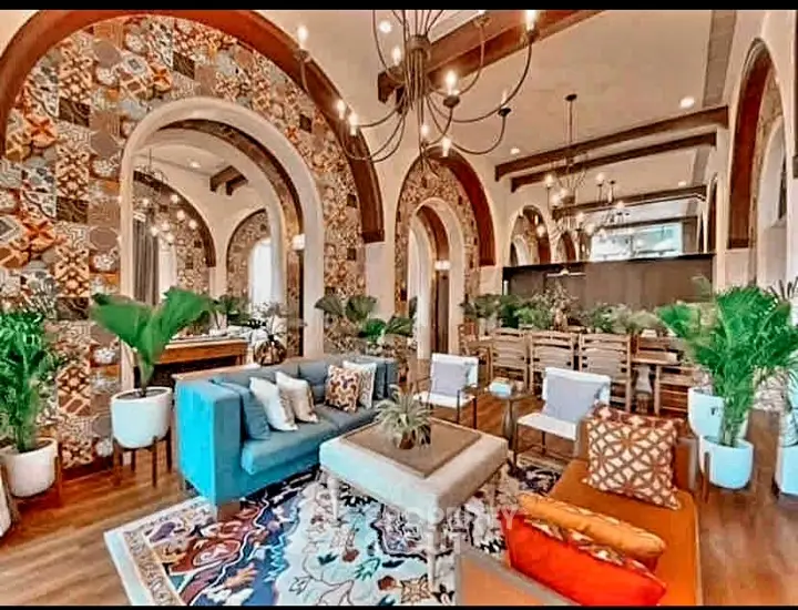 Luxurious living room with vibrant decor and elegant arches, perfect for entertaining.
