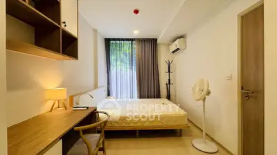 Modern bedroom with natural light, wooden furniture, and minimalist decor.