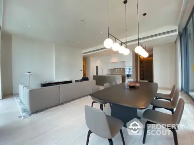 Luxurious open-plan living and dining area with modern furnishings and elegant lighting