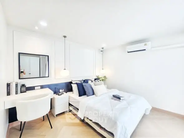 Bright and modern bedroom with stylish decor and air conditioning unit.