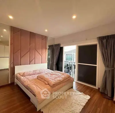 Spacious bedroom with modern decor and large window for natural light