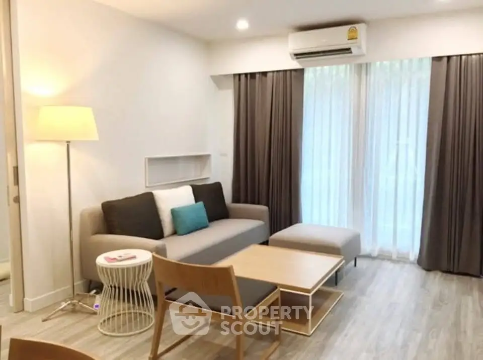 Modern living room with stylish furniture and large window for natural light.