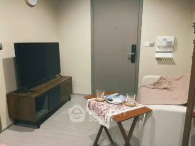 Cozy living room with modern TV stand and comfortable seating area.