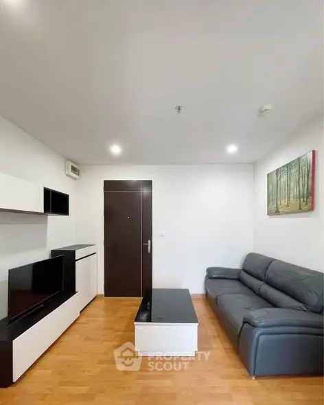 Modern living room with sleek furniture and wooden flooring, perfect for urban living.